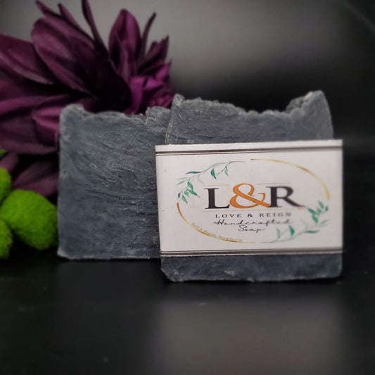 Our soap designs and fragrances are made with natural colorants and pure essential oils. Naturally pigmented with Organic Activated Charcoal. Scented with an invigorating blend of tea tree, rosemary, peppermint, and lavender essential oils.  Great facial bar and good for ally skin types.  Aides in acne, blemish, pore size reduction.  Draws out impurities.  Cruelty free. 